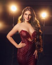 Ravishing Nidhhi Agerwal in a Sequined Red Strapless Gown with Deep Neck Cleavage Photos 04