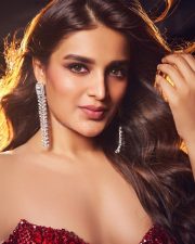Ravishing Nidhhi Agerwal in a Sequined Red Strapless Gown with Deep Neck Cleavage Photos 07