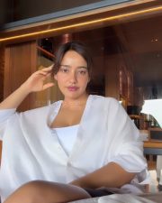 Sanjog Actress Neha Sharma in an Oversized White Shirt over a White Tank Top Bralette Photos 01