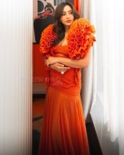 Sensual Neha Sharma in an Orange Floor Length Gown with a Bold Cleavage Cut Out Photos 03