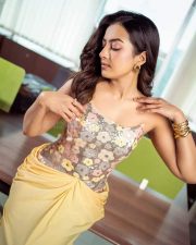 Sexy Catherine Tresa in a Floral Embroidered Corset Top with a Yellow Draped Skirt at Phani Movie Press Meet Stills 04