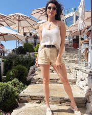 Sexy Karishma Tanna in a Light Beige Camisole Top with a High Waist Khaki Shorts Photos 02