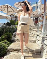 Sexy Karishma Tanna in a Light Beige Camisole Top with a High Waist Khaki Shorts Photos 03
