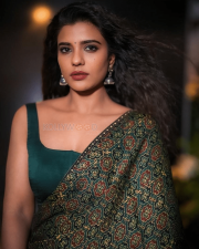 Striking Actress Aishwarya Rajesh in a Deep Green Printed Saree Teal Blouse Photos 02