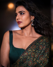 Striking Actress Aishwarya Rajesh in a Deep Green Printed Saree Teal Blouse Photos 04