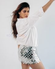Striking Actress Yashika Aannand in a White Shirt and Silver Disc Mini Skirt Photos 04