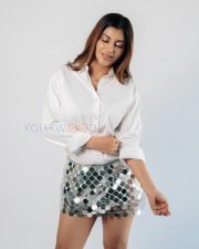 Striking Actress Yashika Aannand in a White Shirt and Silver Disc Mini Skirt Photos 07