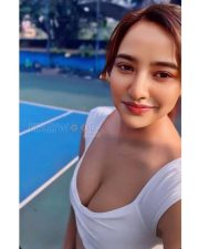 Striking Neha Sharma Cleavage in a White Sports Crop Top Photos 01