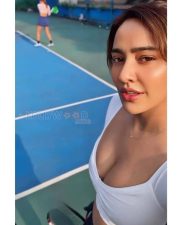 Striking Neha Sharma Cleavage in a White Sports Crop Top Photos 02