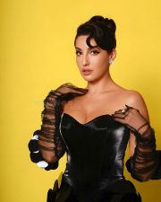 Stunning Bold Nora Fatehi in a BLack Corset Dress with Elbow Length Gloves Photos 02