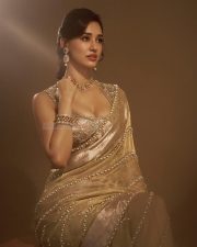 Stunning Indian Actress Disha Patani in a Gold Colored Saree with a Matching Embroidered Sleeveless Blouse Photos 01