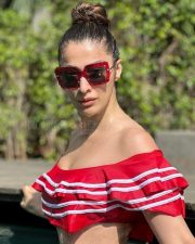 Stunning Raai Laxmi Reading in a Red Swimsuit Photos 04