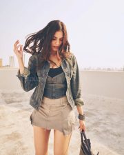 Stylish Actress Malavika Mohanan in a Denim Jacket and Khaki Mini Skirt Photos 01