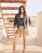 Stylish Actress Malavika Mohanan in a Denim Jacket and Khaki Mini Skirt Photos 02