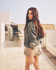 Stylish Actress Malavika Mohanan in a Denim Jacket and Khaki Mini Skirt Photos 04