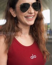 Stylish Actress Rakul Preet Singh in a Red Alo Ribbed Tank Top with White Jeans Photos 03