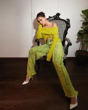 Stylish Ananya Panday in a Green Off Shoulder Knitted Blouse and Denim Jeans Photos 01