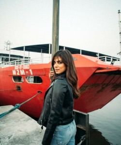 Stylish Malavika Mohanan Standing Near a Red Boat 01