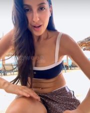 Sultry Nora Fatehi Cleavage in a Navy White Bikini Top and Animal Print Shorts Photos 01