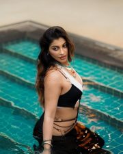 Tamil Glamour Actress Yashika Aannand in a Black Cutout Maxi Dress over a White Lace Bralette Photos 02