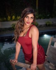 Tamil Glamour Actress Yashika Aannand in a Deep Red Corset Bodysuit with a Red Sequined Mini Skirt Pictures 02