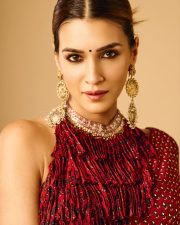 Tere Ishk Mein Actress Kriti Sanon in a Fiery Red Printed Pre Draped Saree with a High Collar Backless Blouse Photos 05
