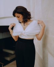 The Game Web Series Shraddha Srinath in a White Ruched Semi Off Shoulder Top with Black Pants Photos 01