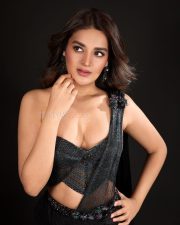 The RajaSaab Heroine Nidhhi Agerwal in a Black Pre Draped Saree with a Structured One Shoulder Corset Blouse Photos 06