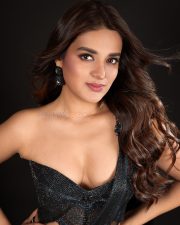 The RajaSaab Heroine Nidhhi Agerwal in a Black Pre Draped Saree with a Structured One Shoulder Corset Blouse Photos 08