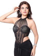 The RajaSaab Heroine Nidhhi Agerwal in a Bold Black Lace Sheer Corset Halter Top with a Low Rise Maxi Skirt Photos 03