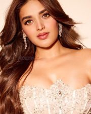 The RajaSaab Heroine Nidhhi Agerwal in a Cream Strapless Floor Length Corset Bodice with a Thigh High Slit Gown Pictures 01