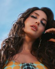 Vibrant Actress Nora Fatehi in a Multicolor Abstract Polka Dot Bodysuit Photos 01