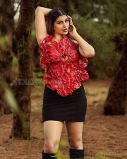 Vivacious Actress Yashika Aannand in a Red Sculptural Floral Top with Black Mini Skirt and Boots Photos 05