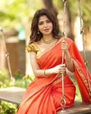Adorable Iswarya Menon in an Orange Saree with a Golden Puff Blouse Photos 04
