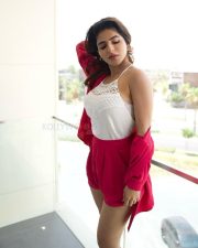Bazooka Actress Iswarya Menon in a White Halter Neck Lace Top with a Vibrant Red Pink Shirt and Matching Shorts Photos 01