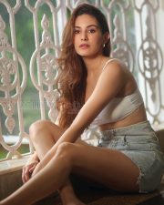 Charming Actress Amyra Dastur in a White Crop Cami Top and Denim Shorts Photos 02