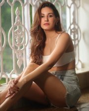 Charming Actress Amyra Dastur in a White Crop Cami Top and Denim Shorts Photos 03