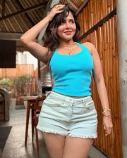 Charming Actress Iswarya Menon in a Blue Tank Top and White Denim Shorts Photos 04