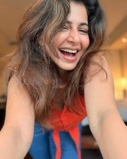 Charming Actress Iswarya Menon in a Red Sleeveless Button Down Top Photos 03