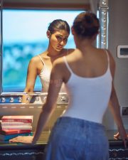 Glam Mouni Roy in a White Tank Top and Blue Denim Photos 04