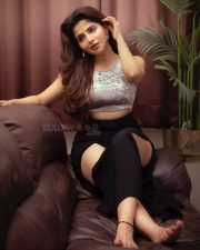 Hot Iswarya Menon Thighs on the Couch in a Black Slit Skirt and Short Silver Crop Top Photos 01