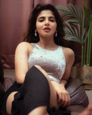 Hot Iswarya Menon Thighs on the Couch in a Black Slit Skirt and Short Silver Crop Top Photos 04