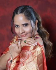 Kollagottinadhiro Actress Anasuya Bharadwaj in a Traditional Red and Gold Kanchipuram Silk Saree with a Matching Red Silk Blouse Pictures 01