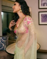 Mesmerizing Actress Mouni Roy in a vibrant fuchsia and cream embroidered lehenga choli with sheer drape photos 03