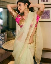 Mesmerizing Actress Mouni Roy in a vibrant fuchsia and cream embroidered lehenga choli with sheer drape photos 07