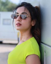 Passionate Actress Sonal Chauhan in a Neon Lime Green Ribbed Crop Top and Blue Denim Jeans Photos 01