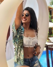 Provocative Shilpa Manjunath in a White Strappy Bikini Crop Top with Mini Denim Shorts Photos 01