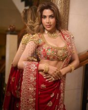 Radiant Actress Nikki Tamboli in a golden embroidered lehenga Photos 02
