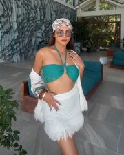 Sexy Krystle Dsouza in a White Mini Skirt and Turquoise Halter Neck Bikini Top Photos 04