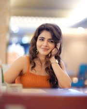 Stylish Iswarya Menon in an Orange Ribbed Crop Top with a High Waisted Blue Jeans Photos 01